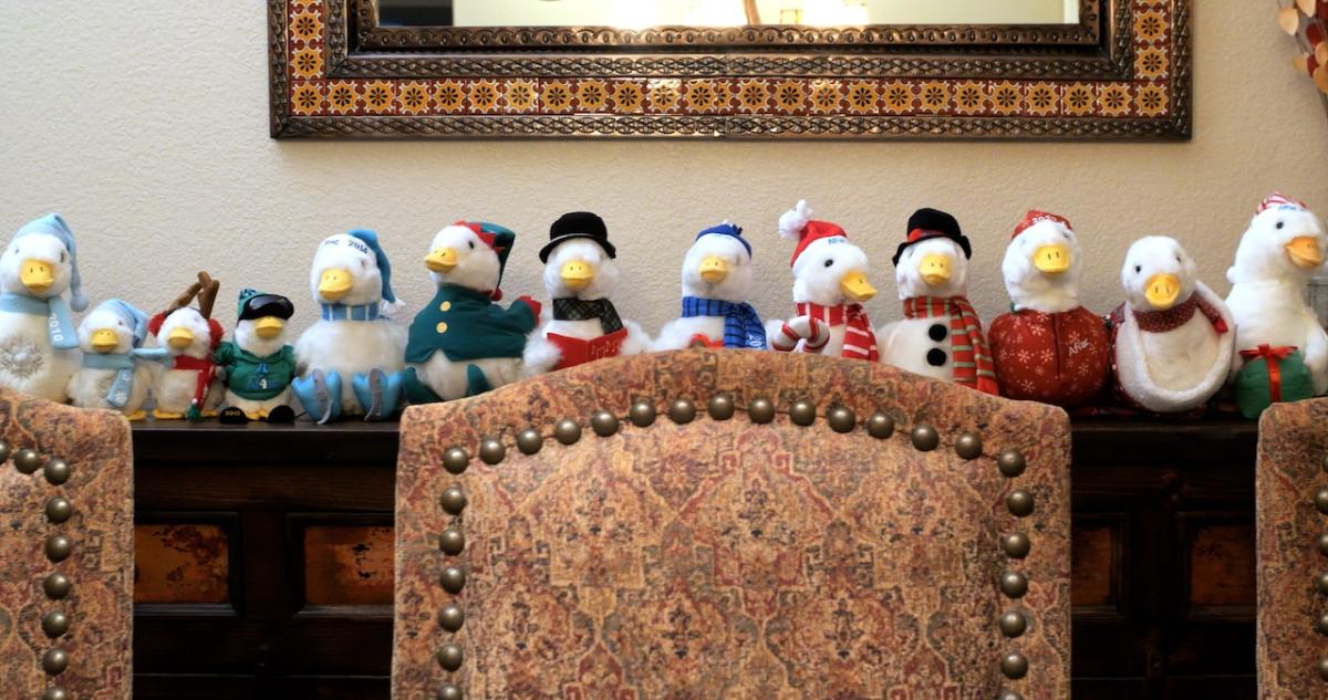 Collection of Aflac Holiday Ducks on a mantlepiece.