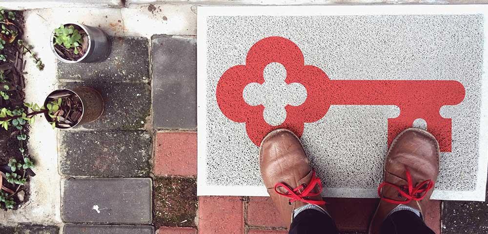 KeyBank home lending. Welcome mat with a red key shown.