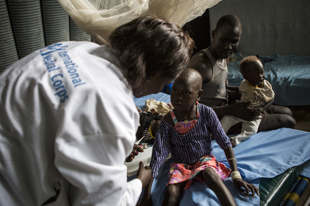 a doctor helps a young child