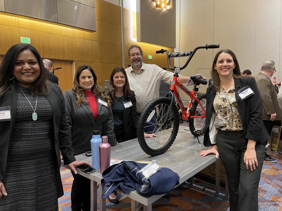 Arrow employees pose with a bike