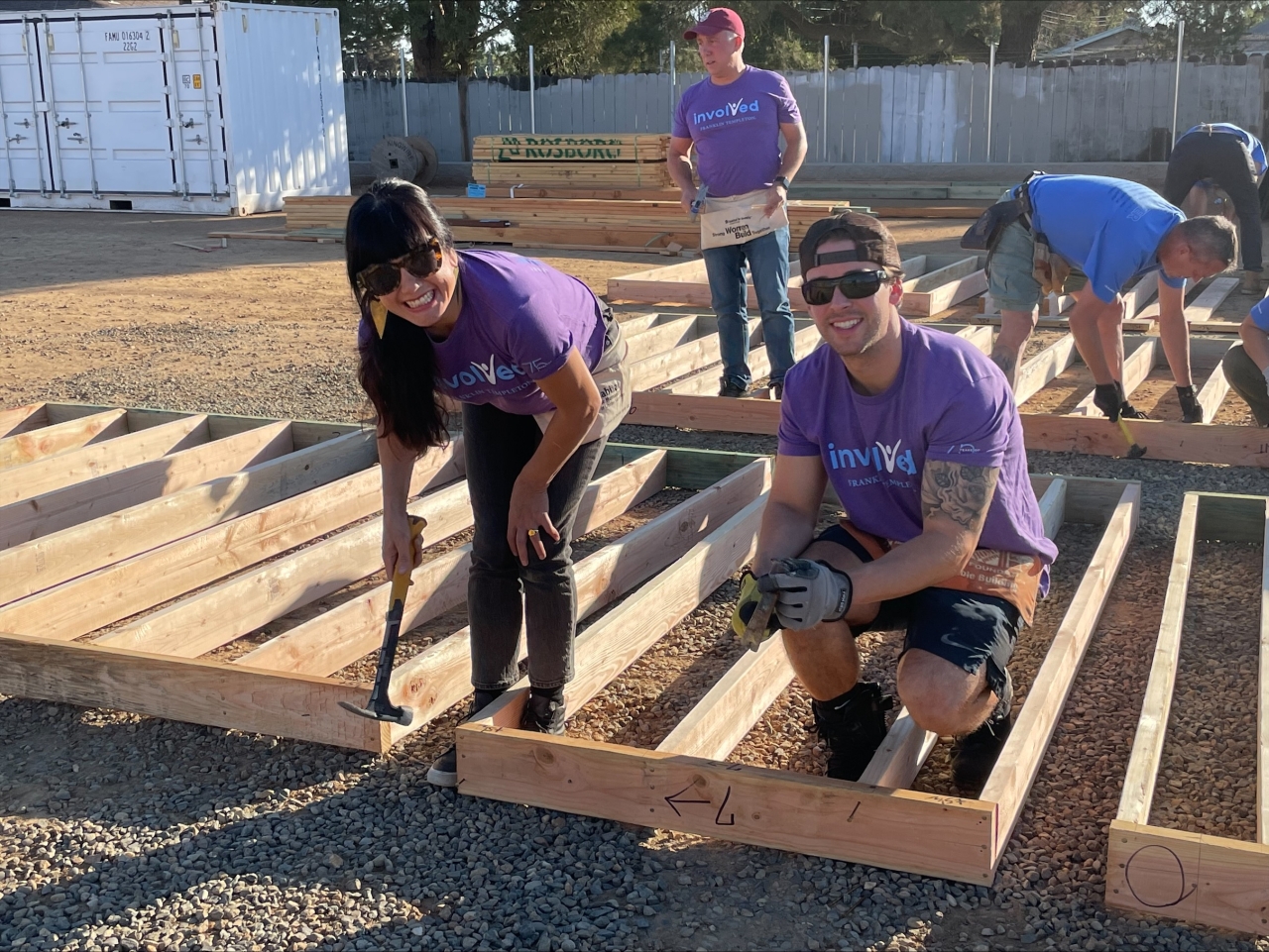 Volunteers help build a home