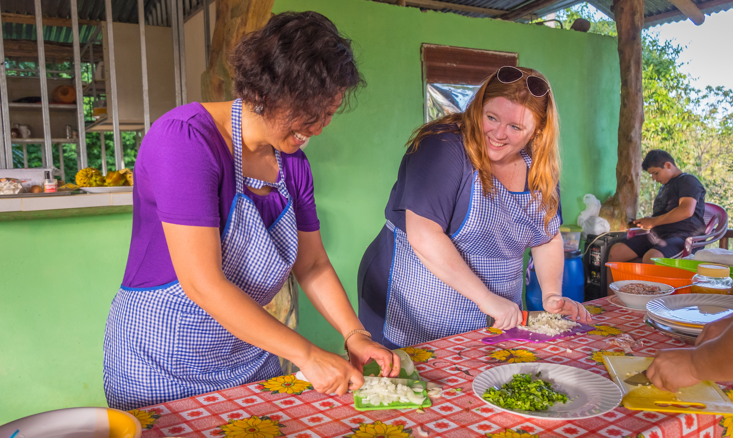 Travelers and locals cook together on an Intrepid Travel trip in Costa Rica — responsible travel