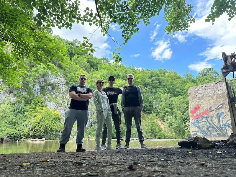 Jelena shown with friends at a river.