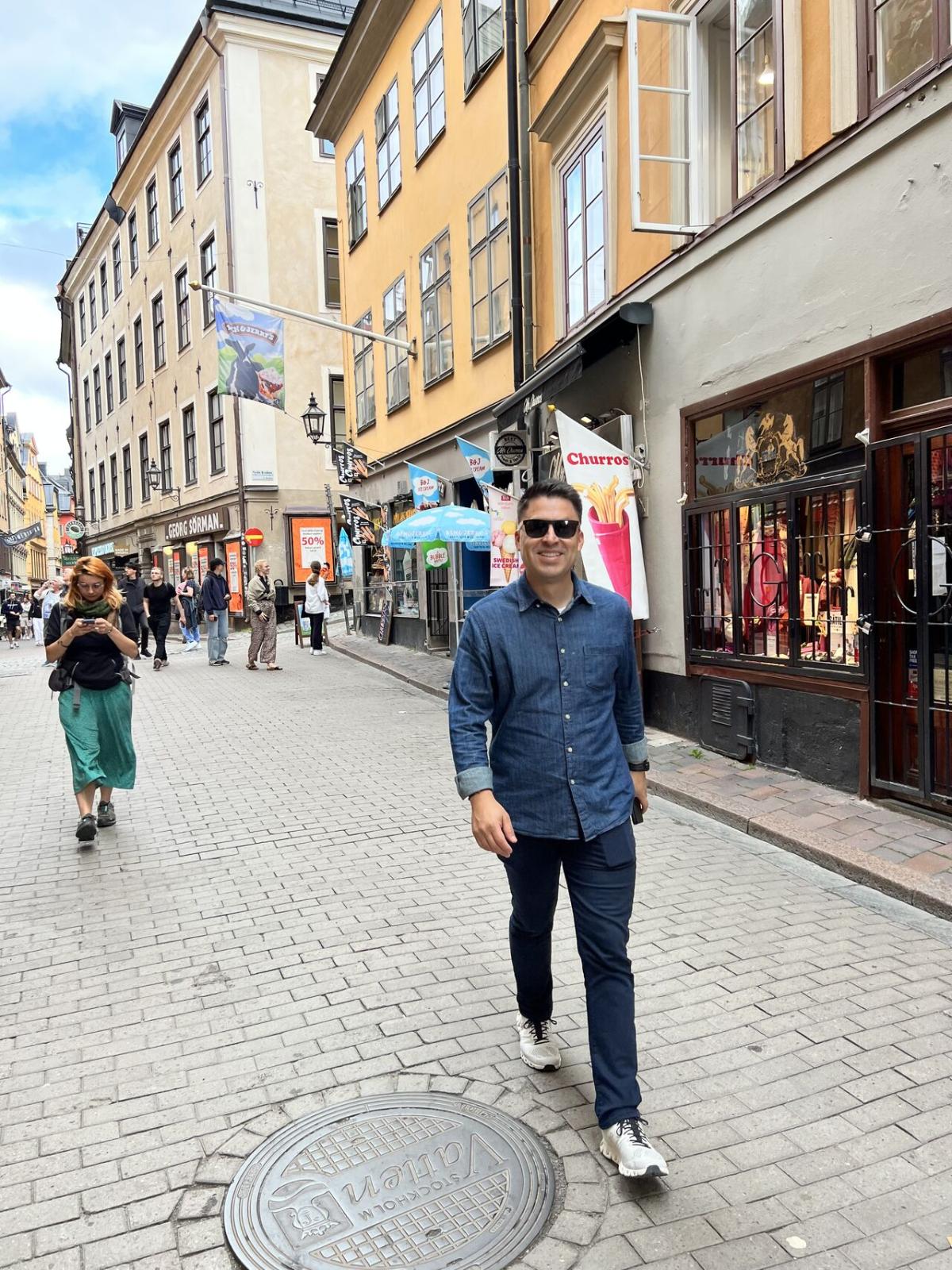 Jorge Alvarez walking down a pedestrian street.