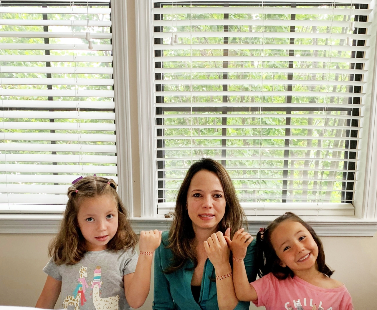 Juanita Pelaez and her daughters wear their menstrual hygiene action bracelets proudly in support of Menstrual Hygiene Day to help end period stigma.