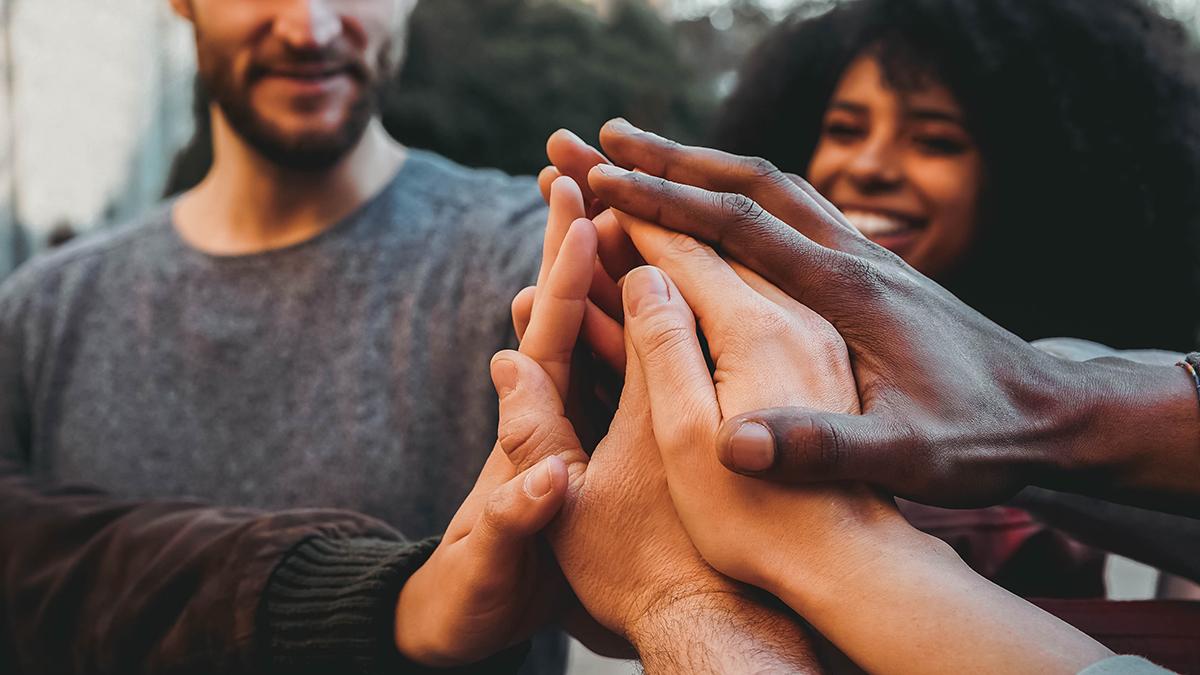 Group of people holding hands.