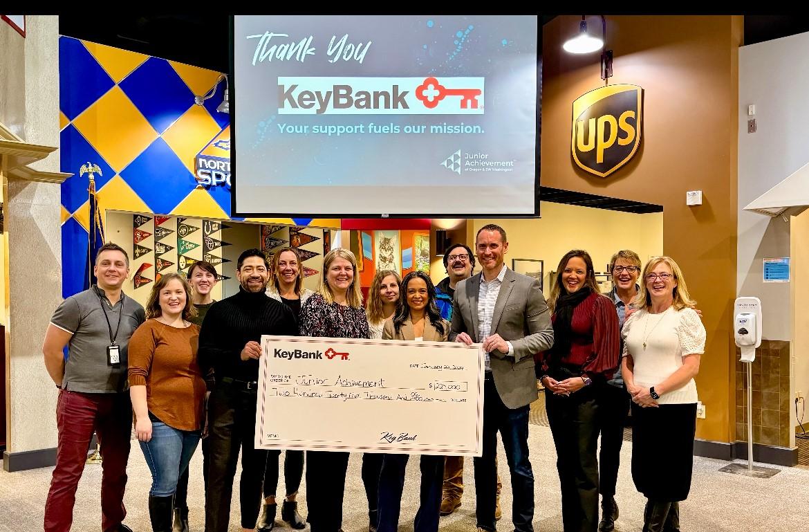 Representatives from KeyBank and Junior Achievement of Oregon shown with a $225,000 grant check.
