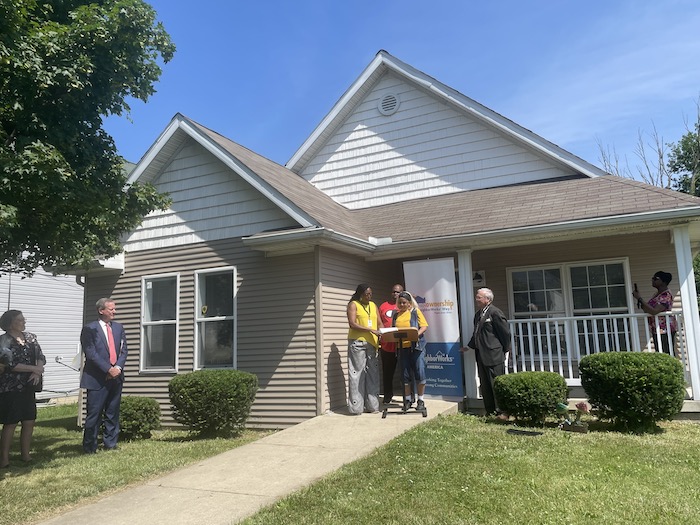 Photo: Representatives from KeyBank, NeighborWorks and The Fair Housing Center welcome Cynthia and Larry Robinson to their new home in West Toledo.