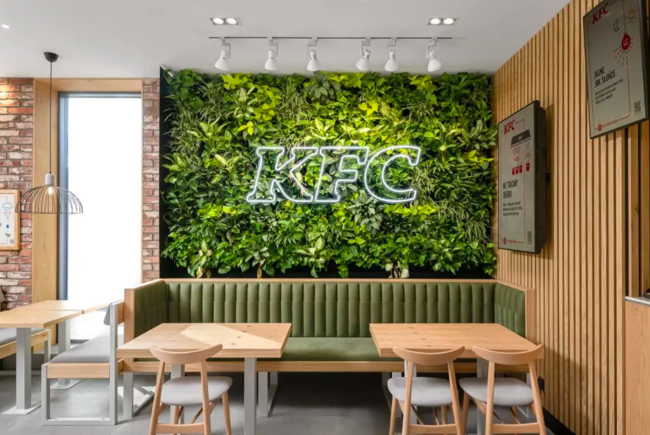 KFC logo against wall plants