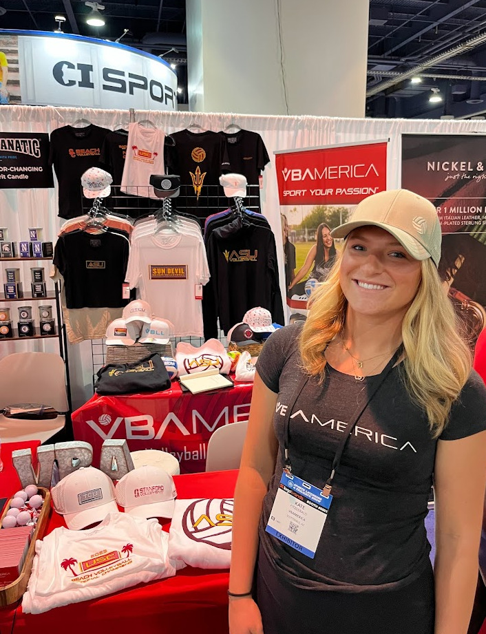 Kate Fitzgerald stands next to a booth of products from her clothing company VBAmerica — student-athletes