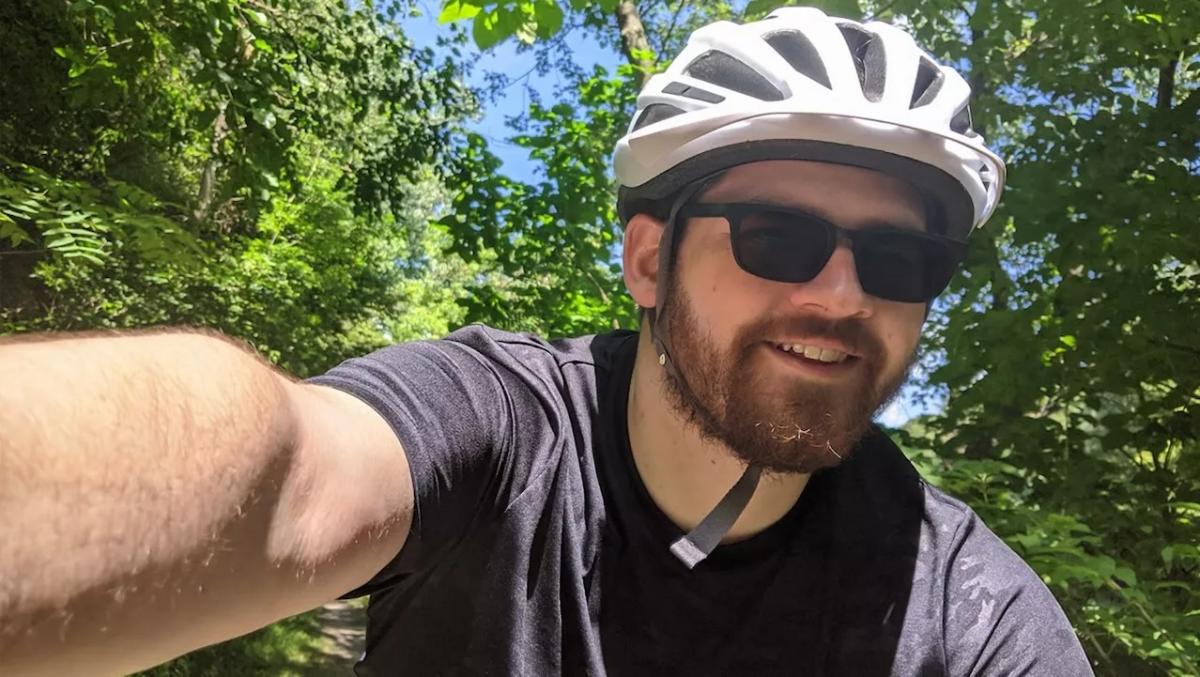 Kevin Arritt shown on a bicycle and wearing a helmet.