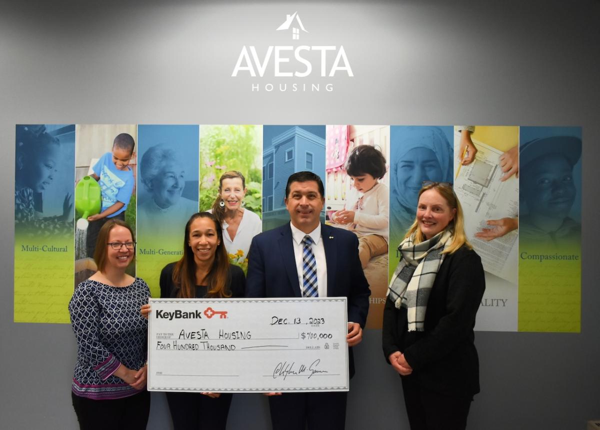 KeyBank Maine Market President Tony DiSotto, second from right, presents a check for $400,000 to (L-R): Avesta Housing Vice President of Property Management & Resident Services Amanda Gilliam, Avesta Housing President & CEO Rebecca Hatfield, and Avesta Housing Vice President of Advancement Sara Olson. (Photo courtesy Avesta Housing)