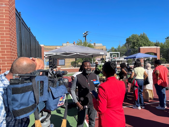 KeyBank volunteer being interviewed at farmers market.