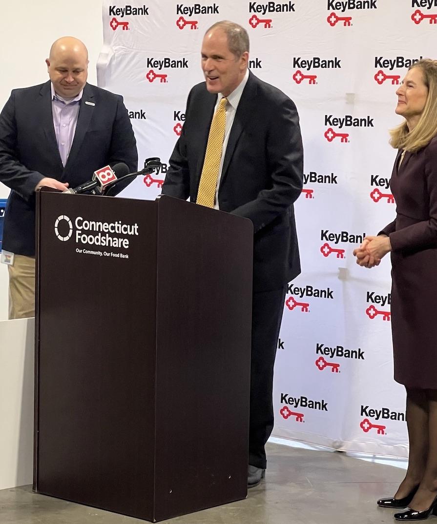 KeyBank's Matthew Hummel speaking to the group from a podium.