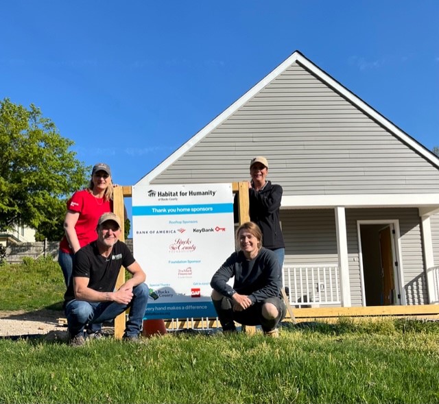 KeyBank volunteers in front of completed home on KeyBank build day.