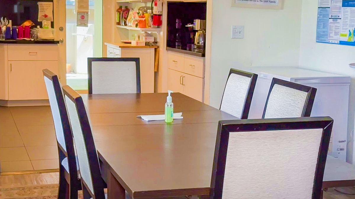 Clean dining table and kitchen.