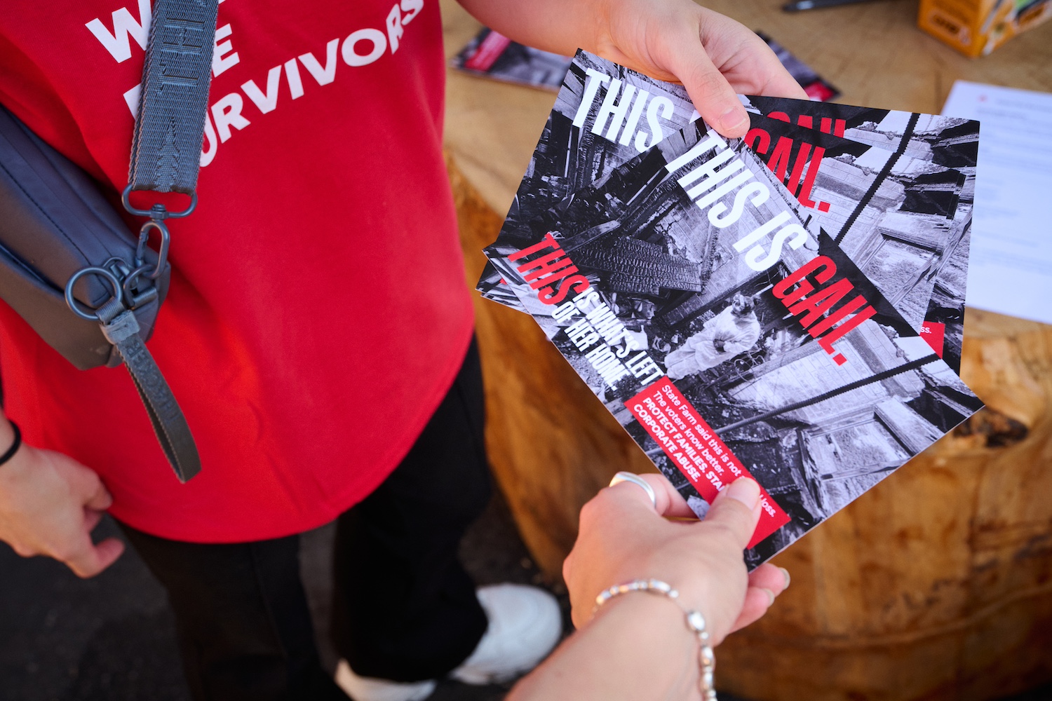 The front of the postcards Eaton Fire Survivors Network event attendees filled out depicts a woman in PPE sifting through her destroyed home.