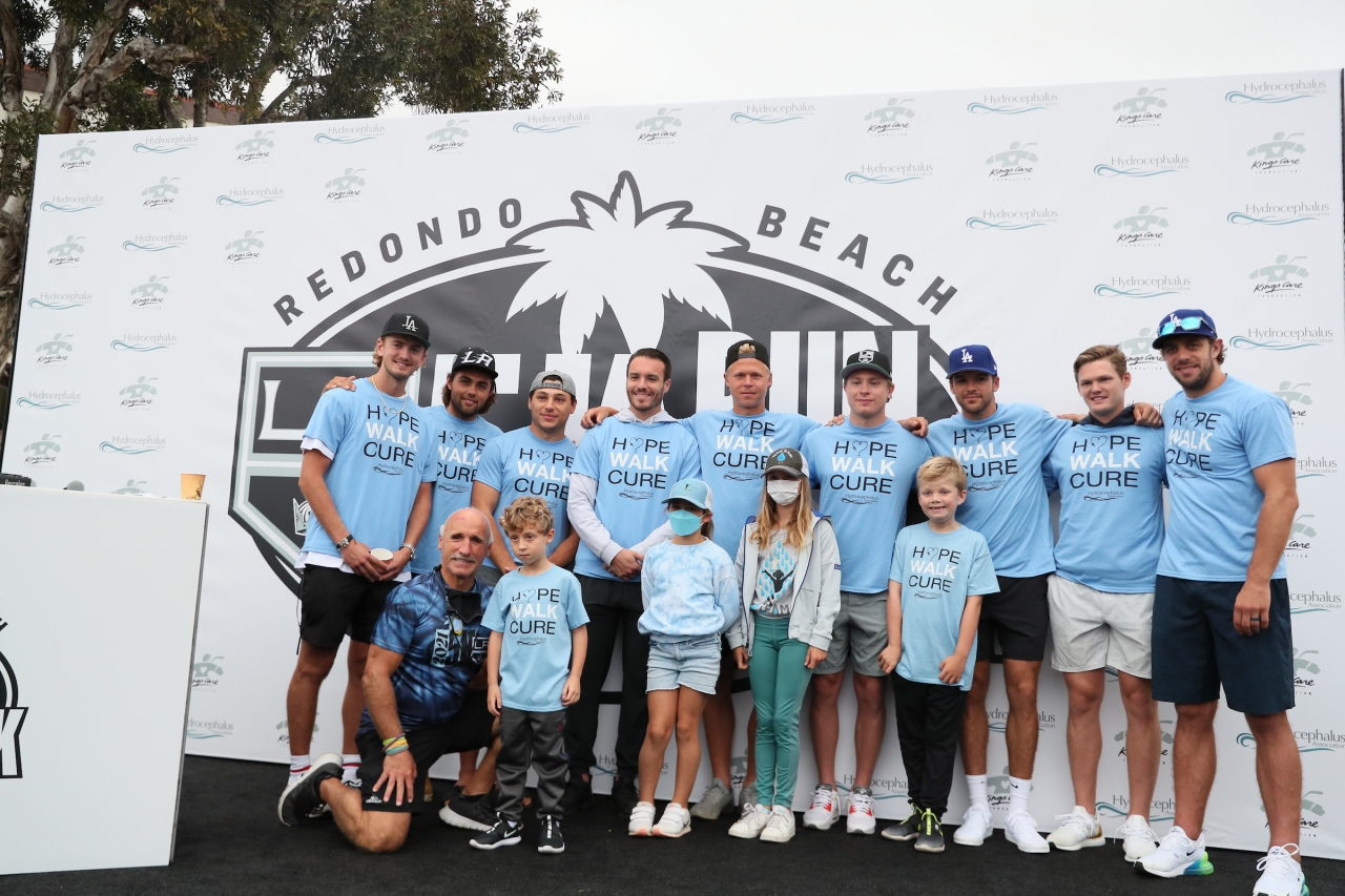 LA Kings players, event emcee Daryl Evans and children pose for a photo after greeting the crowd at the annual LA Kings 5K benefitting the LA Kings Care Foundation and Hydrocephalus Association on September 18, 2021 in Redondo Beach, Calif.