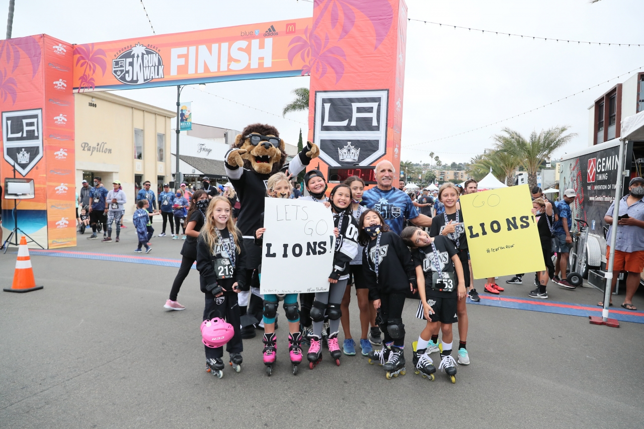 LA Kings mascot Bailey and Daryl Evans cheer on participants with members of the LA Lions, the club’s youth girls club at the annual LA Kings 5K benefitting the LA Kings Care Foundation and Hydrocephalus Association on September 18, 2021 in Redondo Beach, Calif.