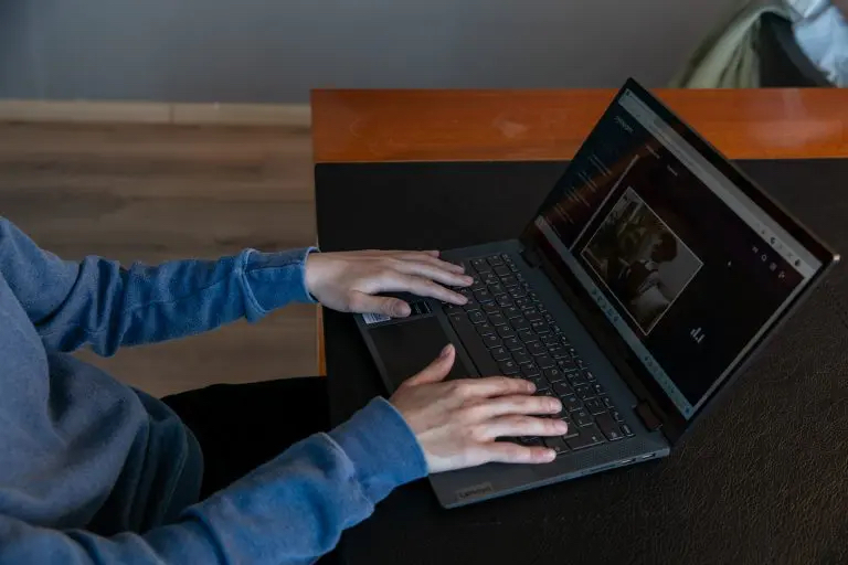 hands resting flat on the keyboard of a BlindLook laptop