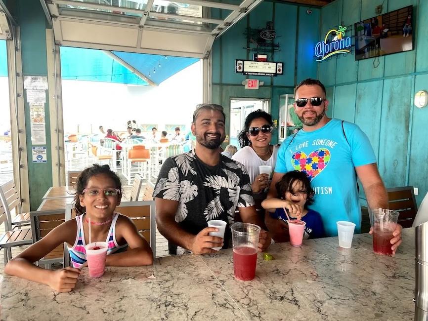 Matt Sheikh shown with his family at a restaurant.