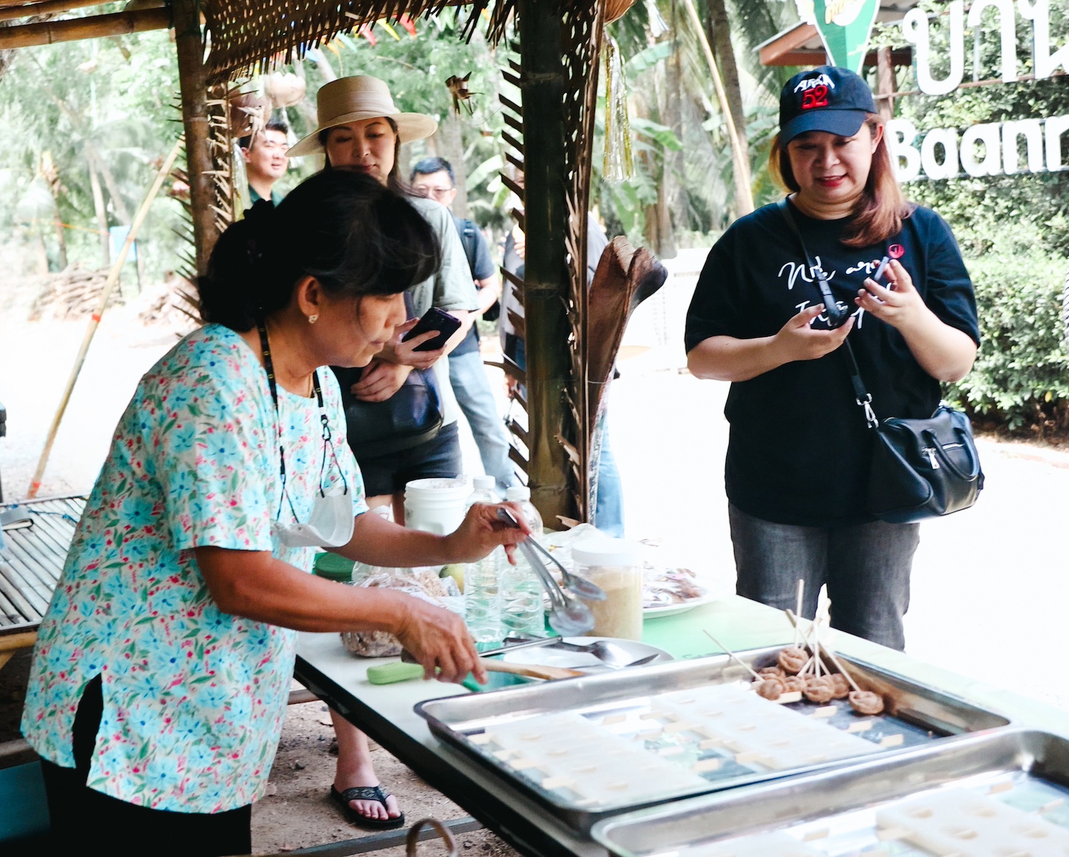 Visitors watch a cooking demonstration as part of an agritourism experience in Thailand listed on the Meaningful Travel Map.