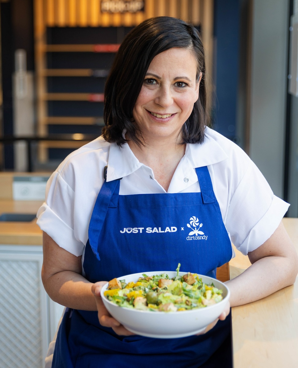 Michelin star chef Amanda Cohen holding the salad she made with Just Salad for Veganuary - new plant-based foods for 2024