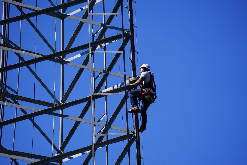 Worker climbing tower