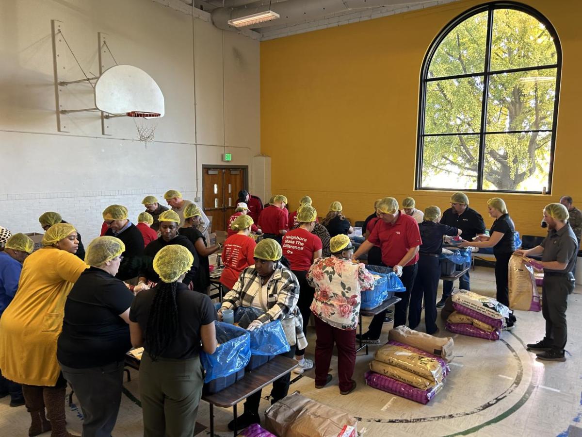 KeyBank and Edna Martin Christian Center volunteers pack meals for those in need.