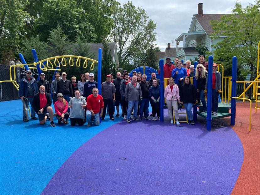 KeyBank volunteers shown in a playground that has been cleaned.