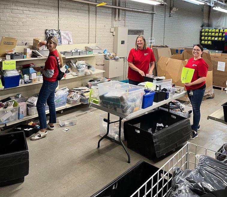 KeyBank volunteers gathering clothes and shoes for kids.