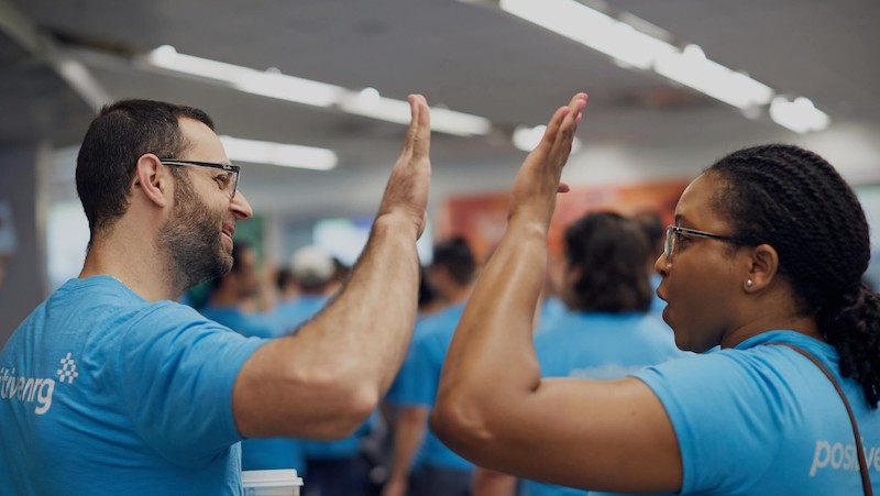 NRG Energy employees giving a high five.