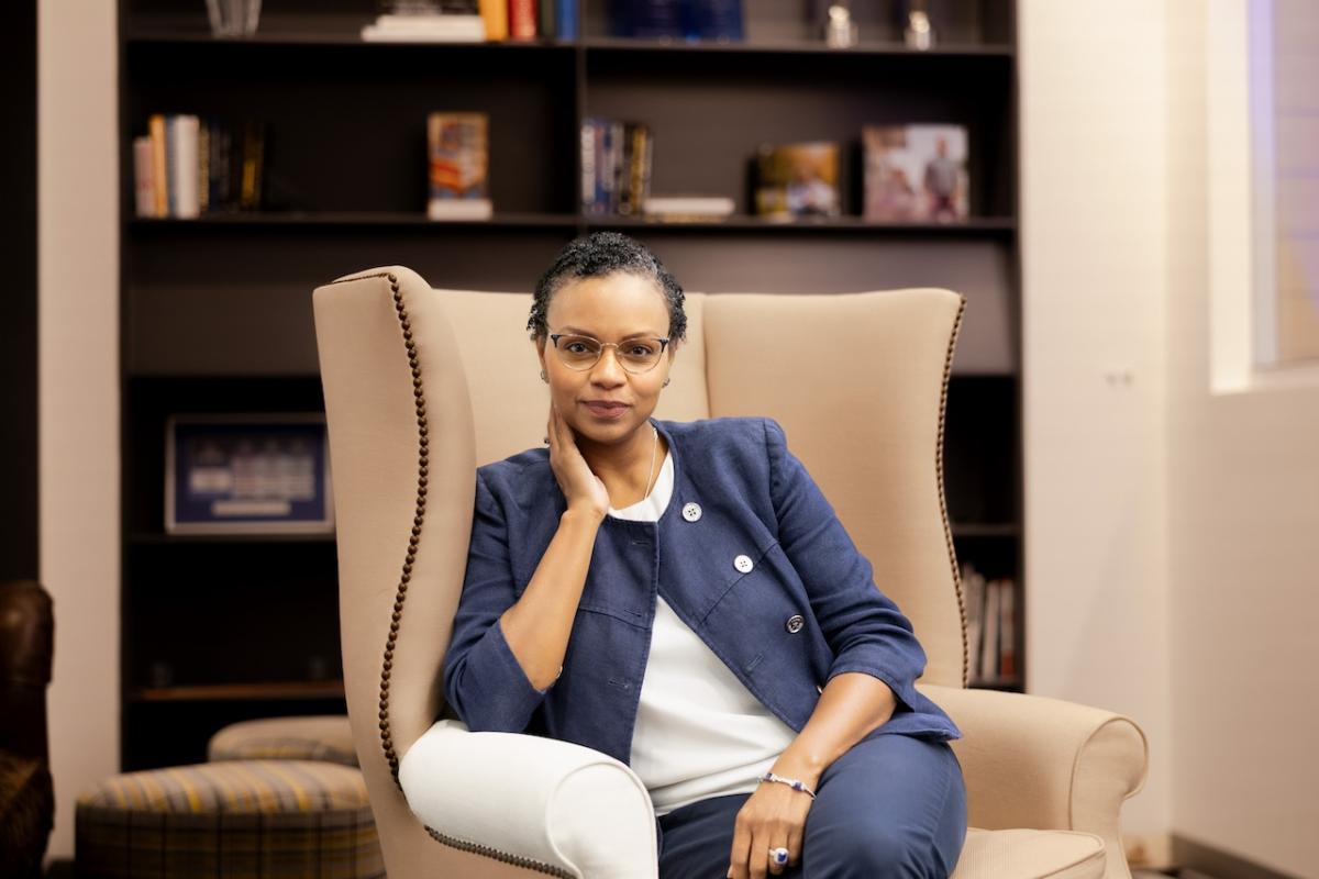 Natalie Lamarque sitting in a high back club chair at Principal headquarters with a soft smile. https://www.principal.com/about-us/purpose/natalie-lamarque-learning-harness-fear