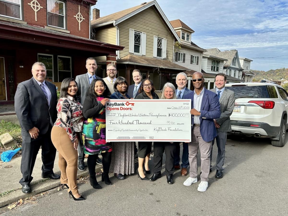 KeyBank and NeighborWorks Team shown with a check for $400,000.