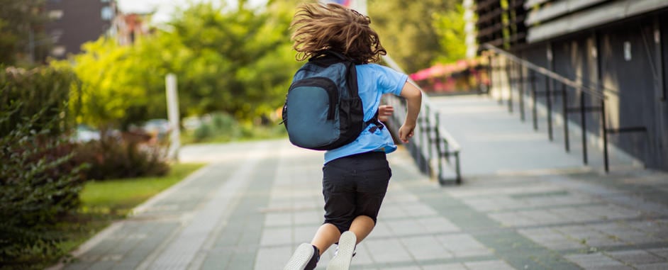 child running in a school unifirm