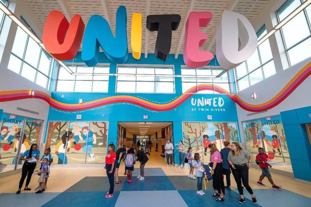 Banner of United at Twin Rivers elementary school. Students shown in the foreground.