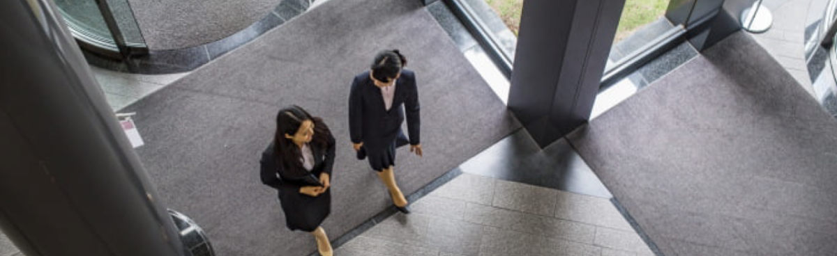 Two people walking through an office