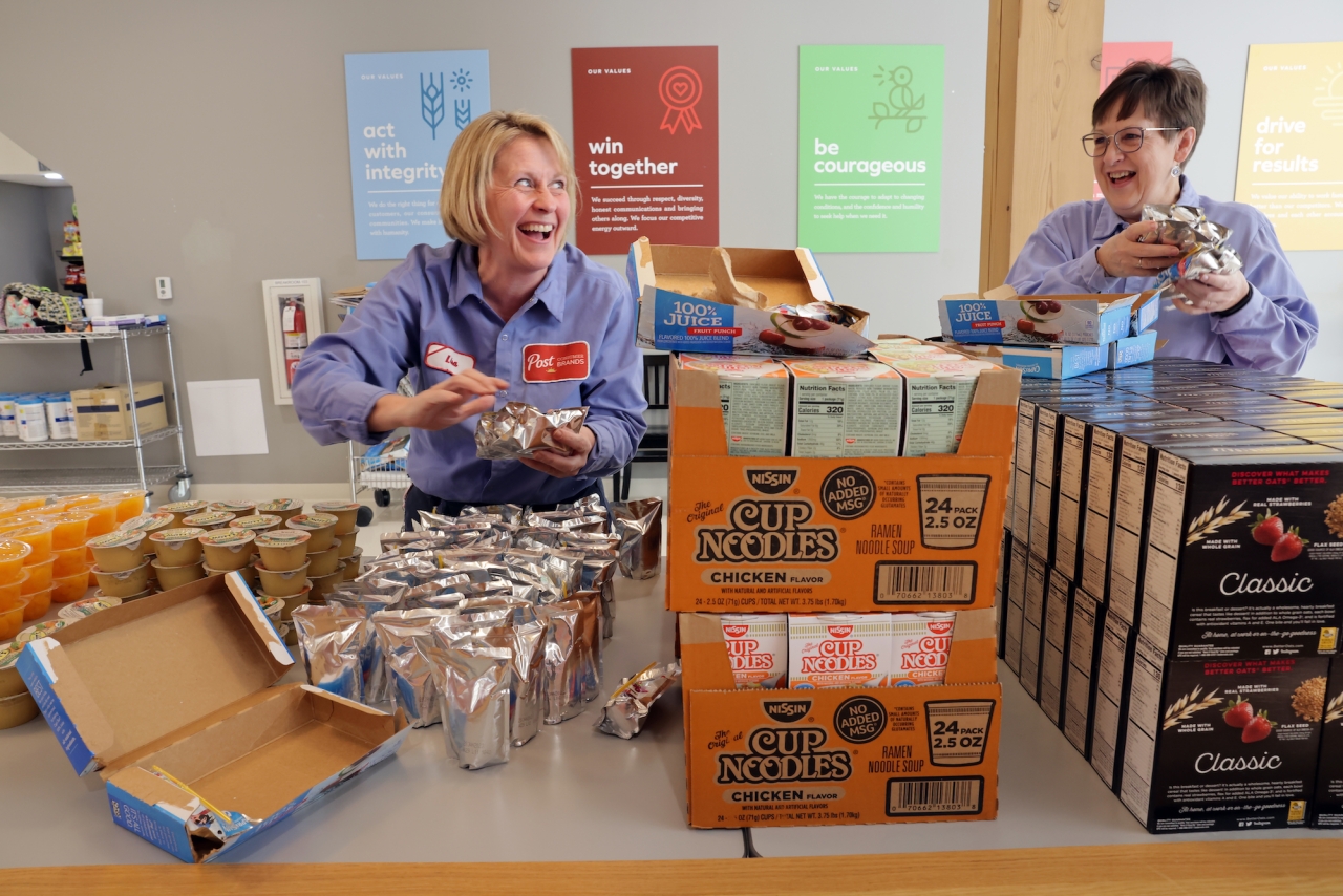 Employees of Post Consumer Brands pack bags of food for local school children as a part of the 'Ingredients for Good' initiative