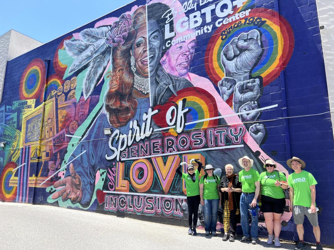 Group poses in front of LGBTQ+ Mural 