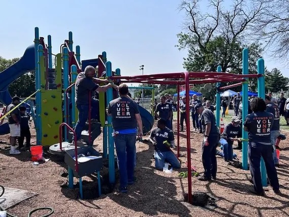 Volunteers working on the jungle gym in the playground.