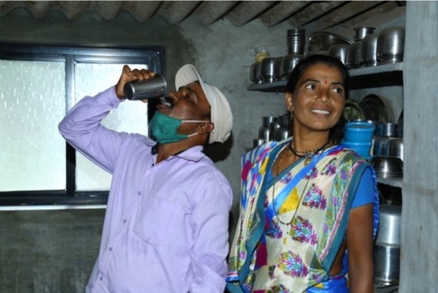 Man drinking water in kitchen 