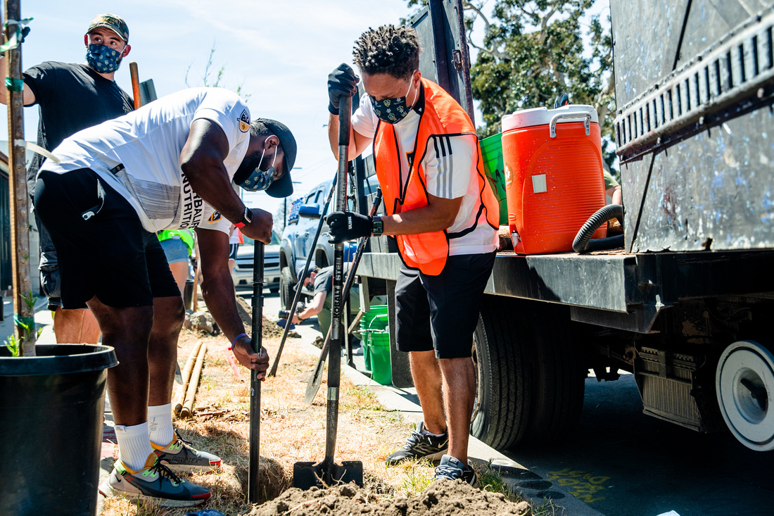 LA Galaxy and MLS star Cobi Jones works alongside LA Galaxy staff and supporters to plant trees in a Watts neighborhood in Los Angeles in conjunction with TreePeople for Earth Month