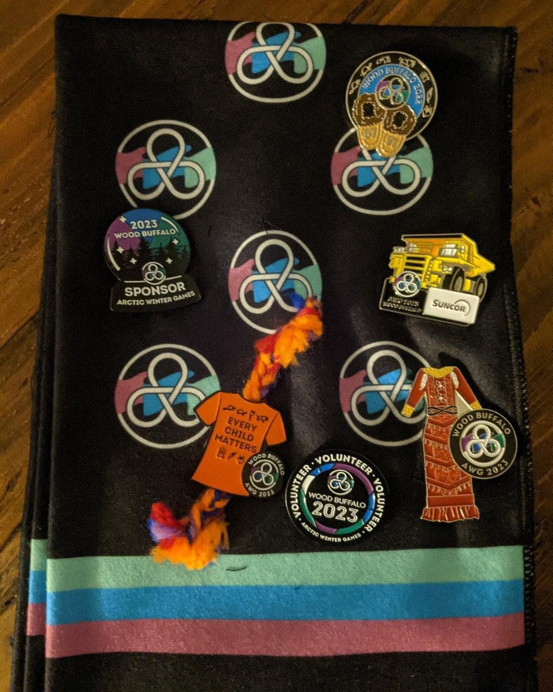 a collection of pins, including a Suncor pin