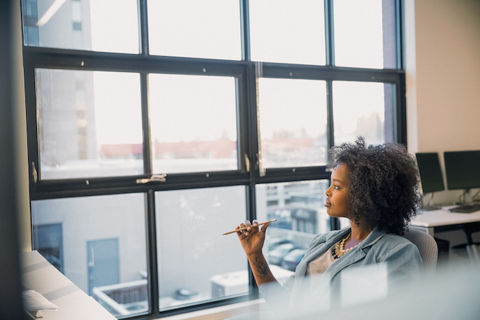 person at desk looking out the window