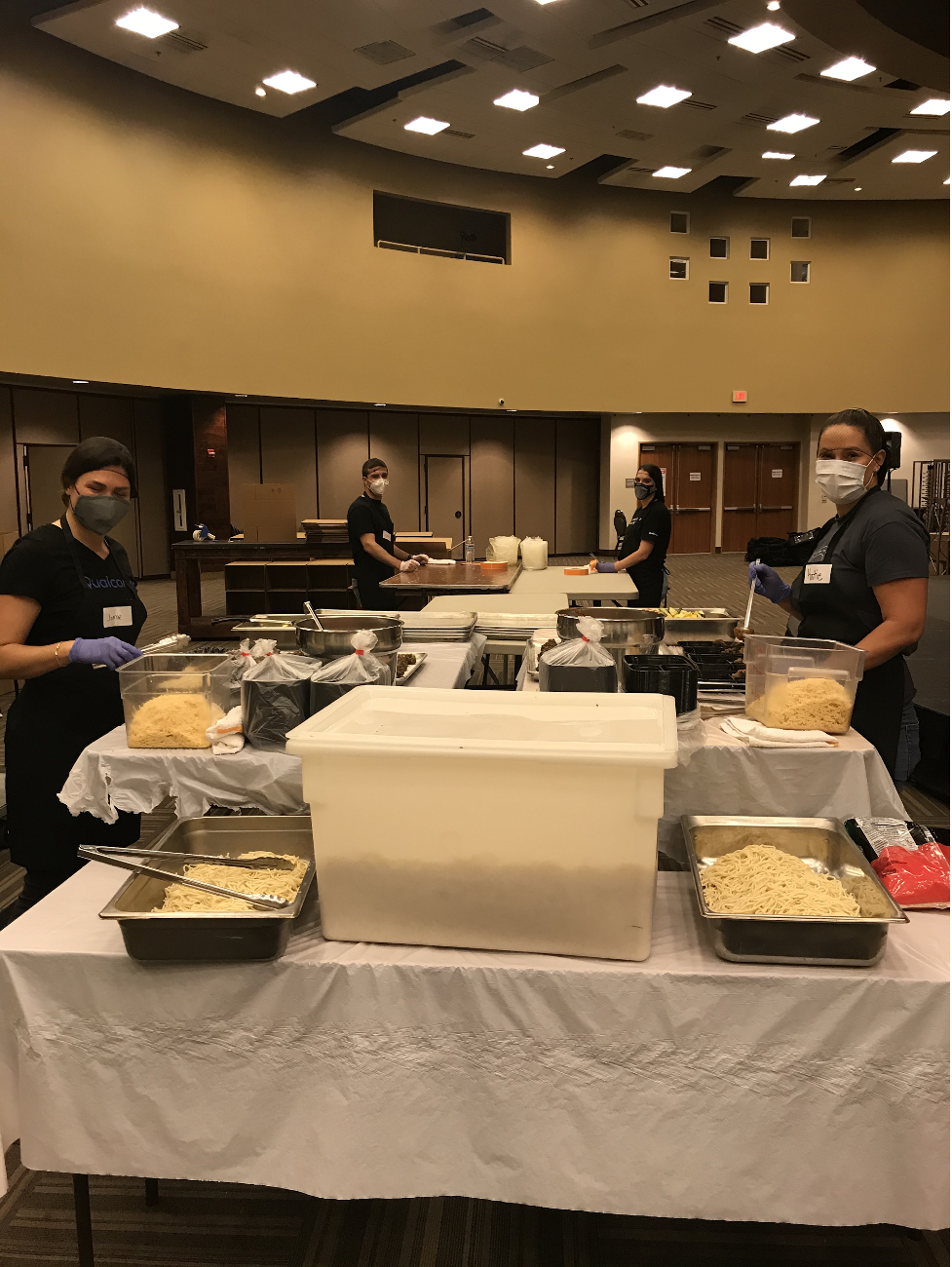 Image of volunteers wearing masks and cooking food