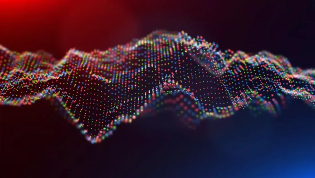 Digital rendering of waves on red, green, and blue dots.
