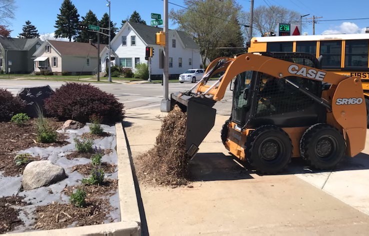 machine lifting and moving dirt