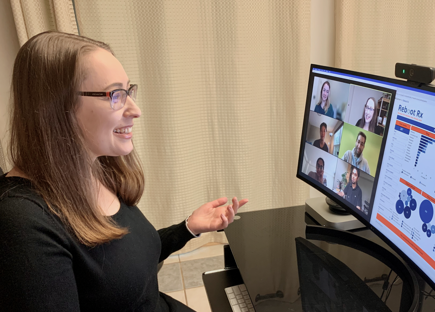 Laura Kleiman - founder of AI driven cancer drug development platform RebootRX - talks with her team on video call