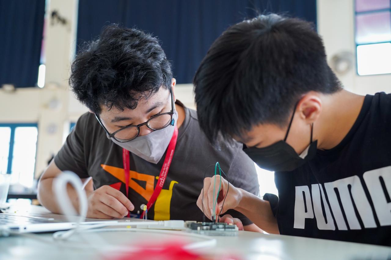 two students work on robotics