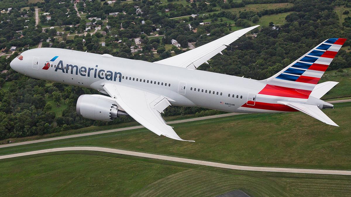An airplane in flight. American logo on the side.